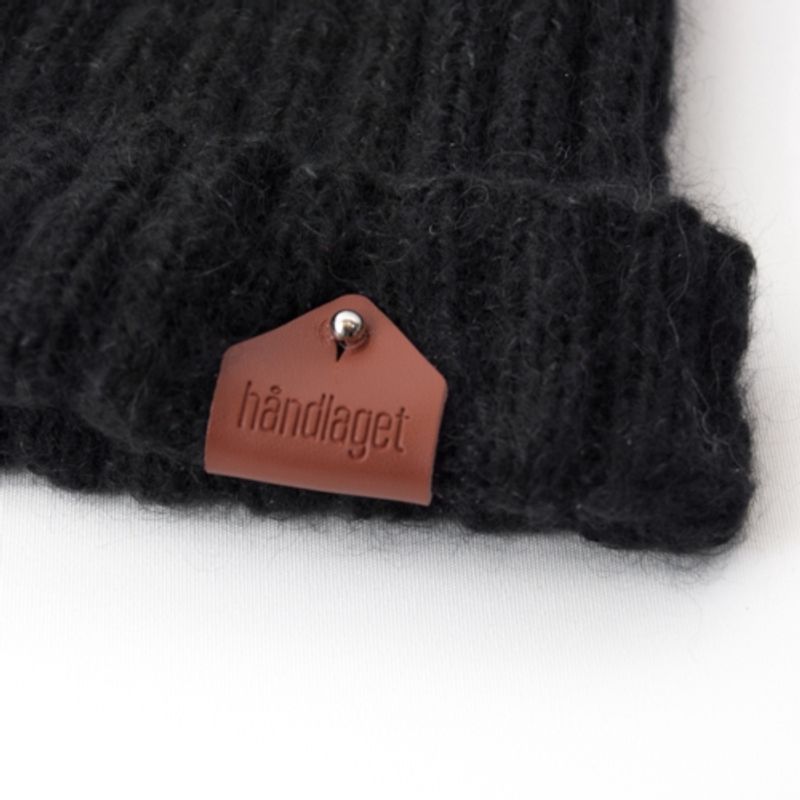 Håndlaget -skinnlapp med knapp